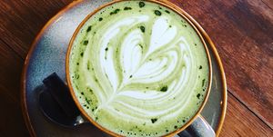 high angle view of matcha tea with froth art at table