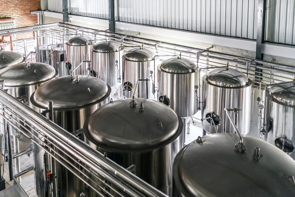High angle view of metallic vats in brewery