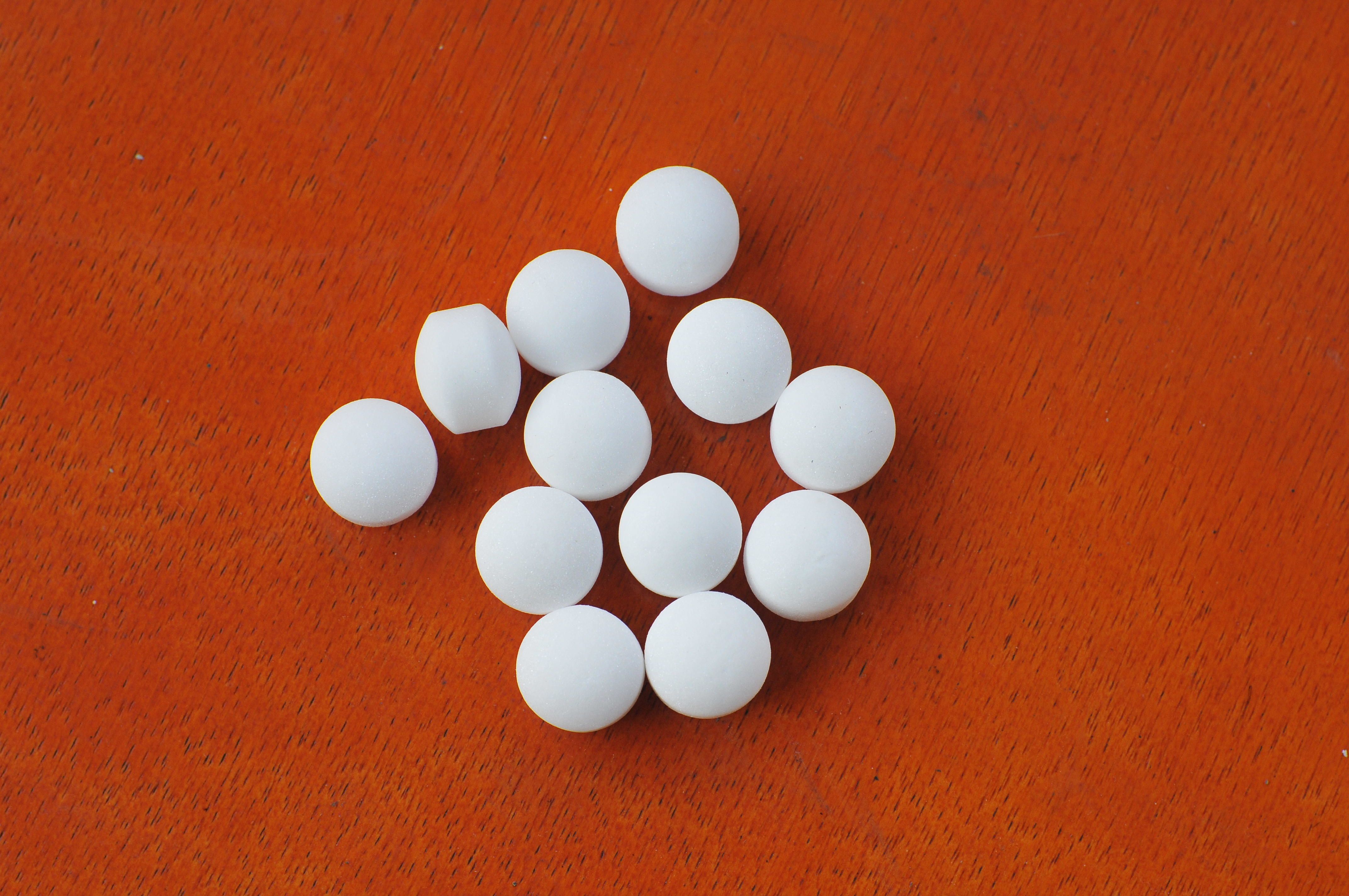 https://hips.hearstapps.com/hmg-prod/images/high-angle-view-of-mothballs-on-wooden-table-royalty-free-image-1582250925.jpg