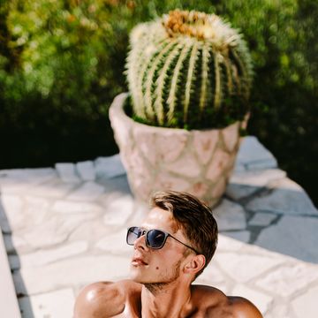 high angle view of shirtless man sitting outdoors