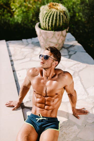 high angle view of shirtless man sitting outdoors