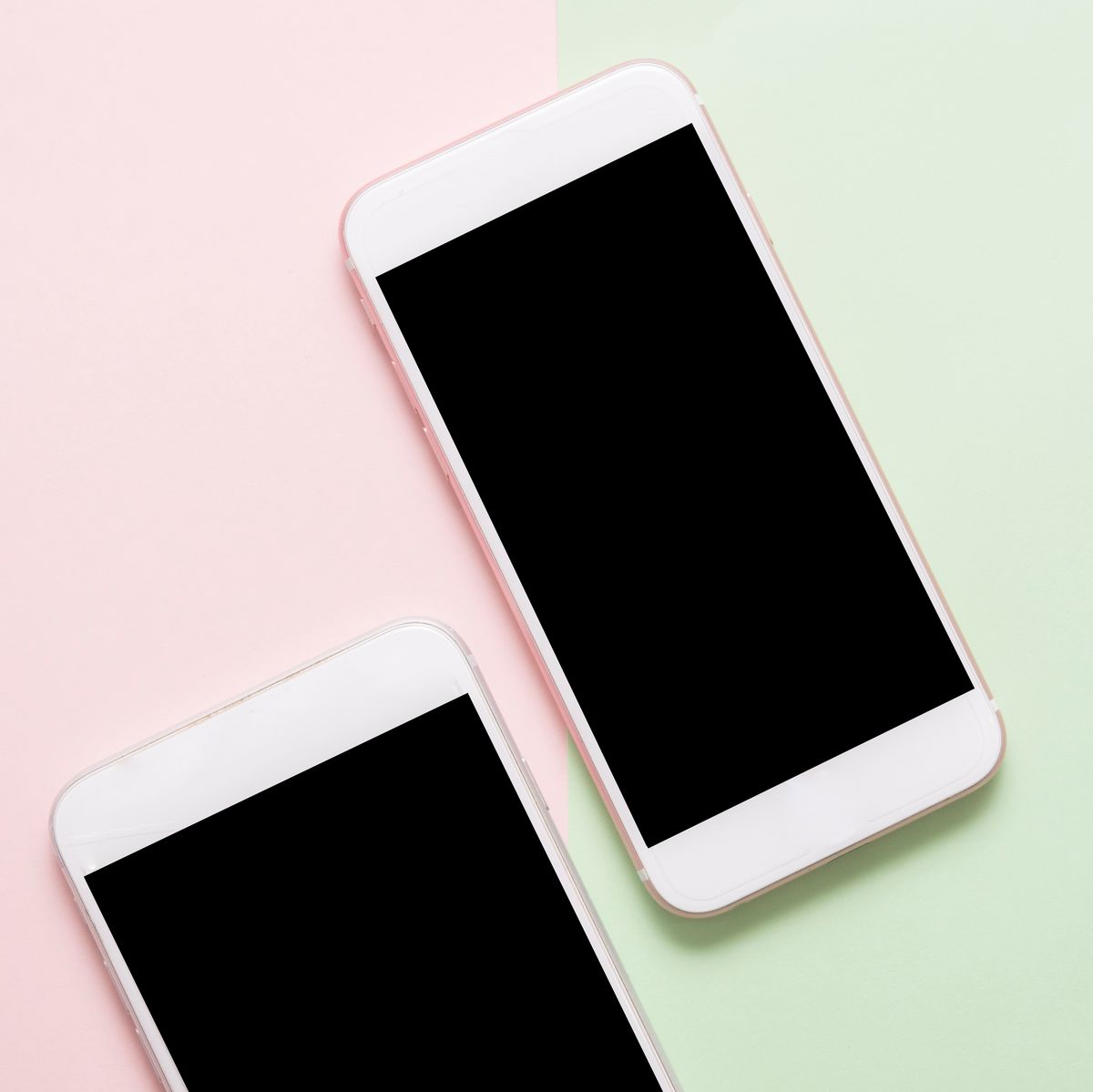 High Angle View Of Smart Phones On Colored Background