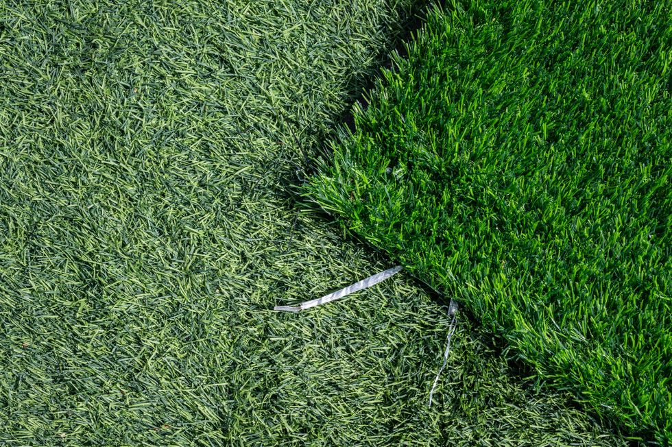high angle view of unfinished green artificial turf used for covering sport arena or garden.