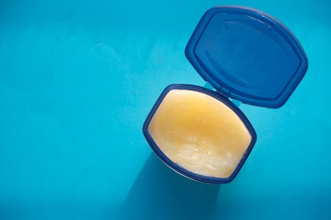 high angle view of white petroleum jelly on blue background
