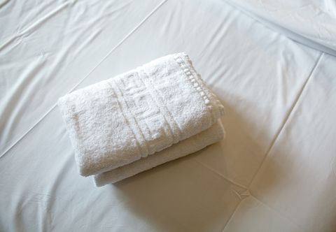 High Angle View Of White Towels On Bed In Room