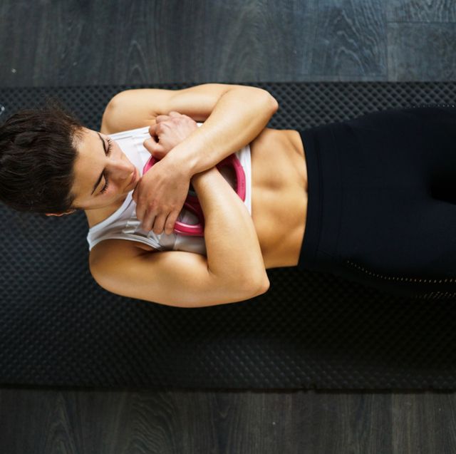 high angle view of woman exercising on floor at gym