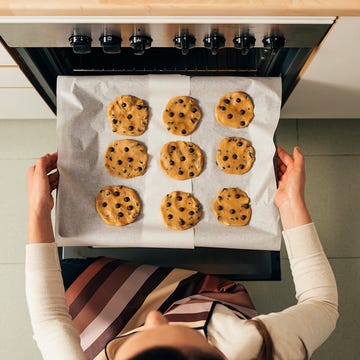 high angle view of woman preparing cookies in kitchen