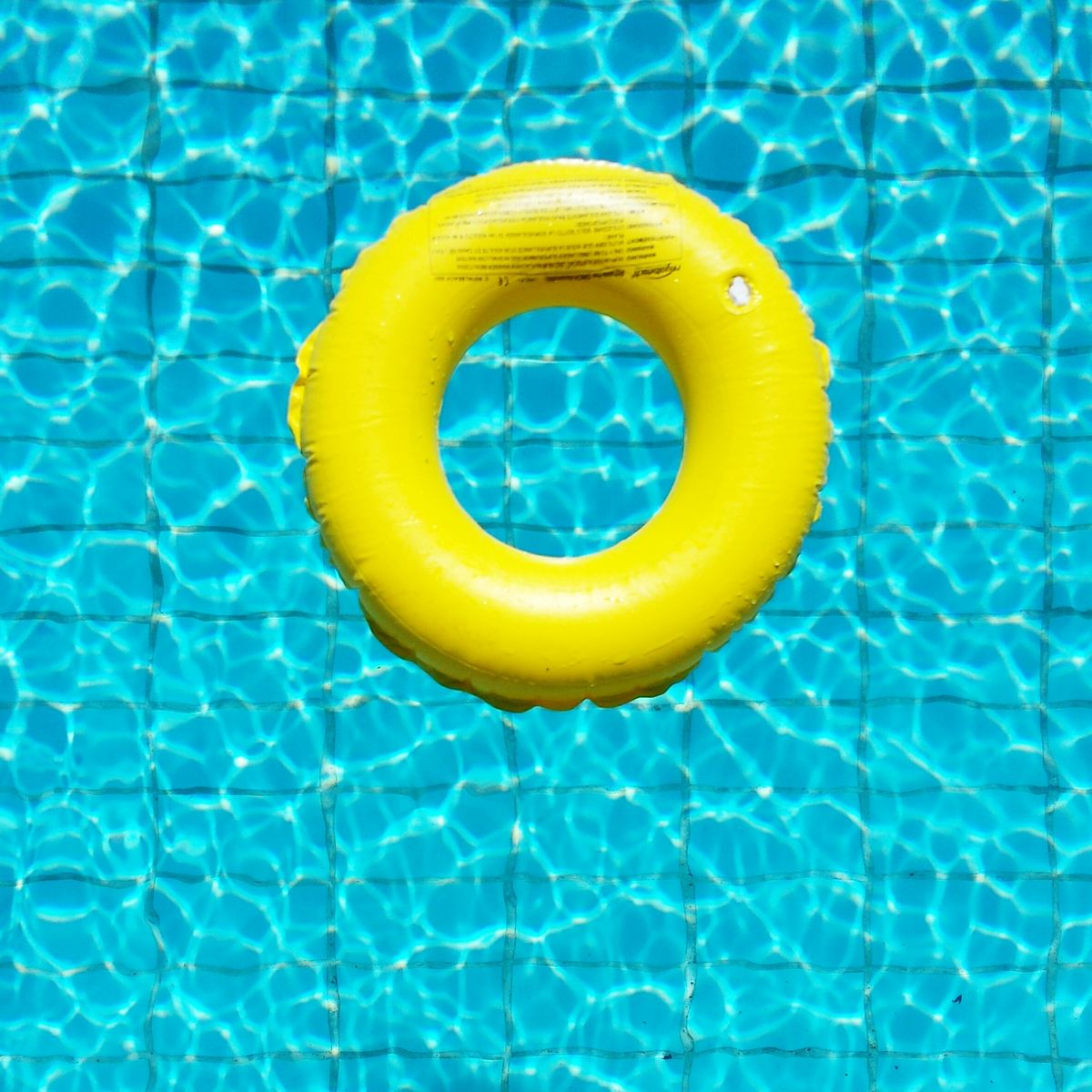 High Angle View Of Yellow Rubber Ring In The Pool