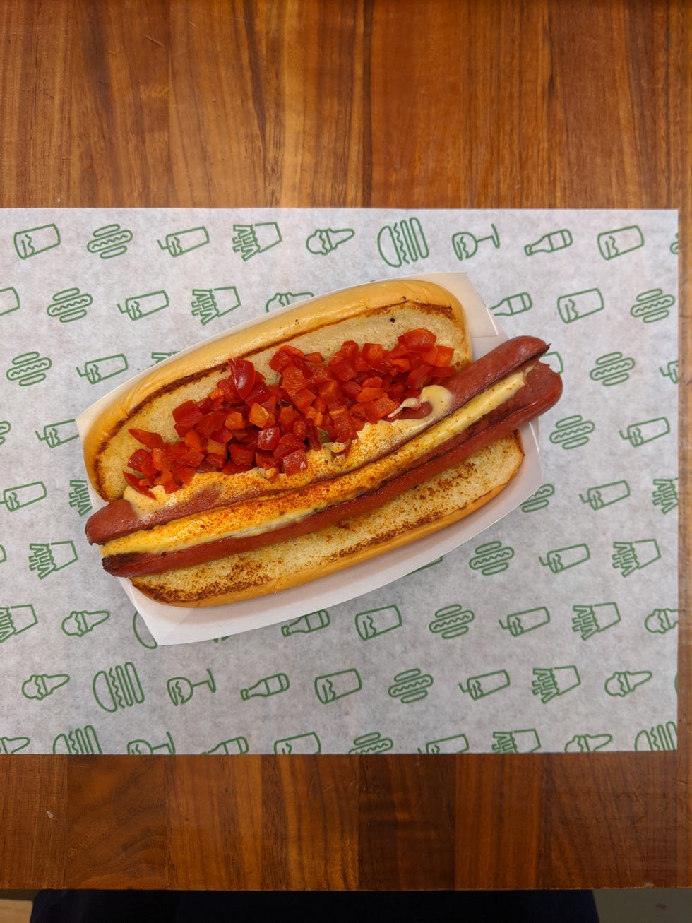 hot dog topped with melted cheese, a hot spice blend of cayenne, garlic and paprika + chopped cherry peppers