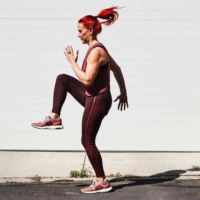 a woman in a tank top and red hair working out