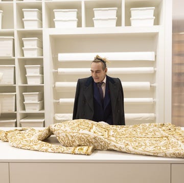 a person standing behind a table with a large snake on it