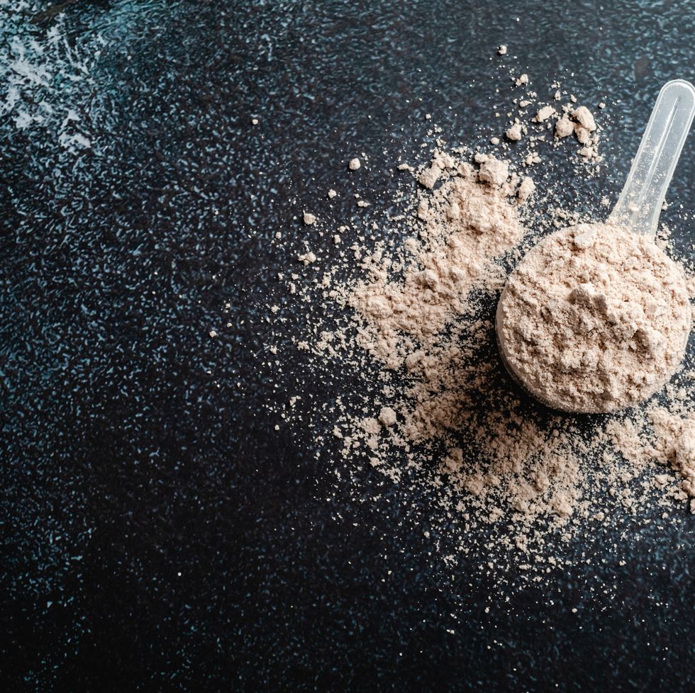 top view whey protein scoop on dark background, copy space