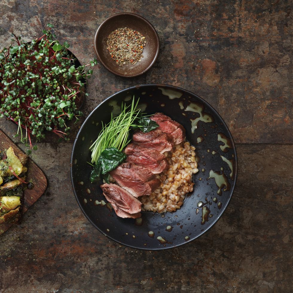 grilled venison steak with spelt grain and microgreen traditional danish smorrebrod with salted saffron mushrooms, potato and homemade mayonnaise flat lay top down composition on dark background