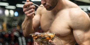 powerful athletic man with great physique eating a healthy salad mockup your brand