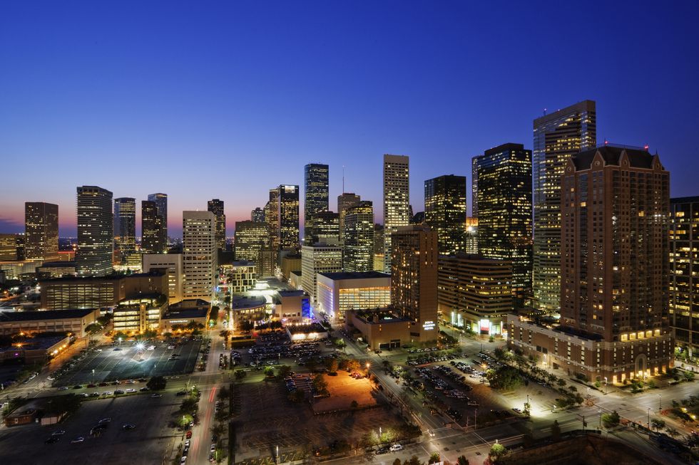High rise buildings in Houston cityscape illuminated at sunset, Texas, United States