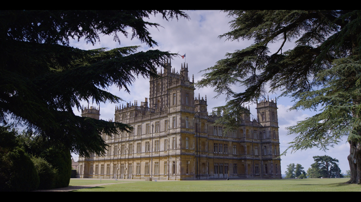 highclere castle framed by trees
