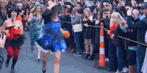 Runners sprint up the hill in high heels and drag