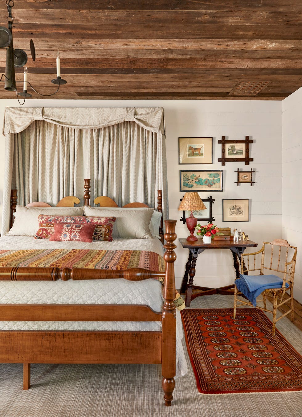 a bedroom with a wood ceiling and wooden furniture and pelmet over the headboard