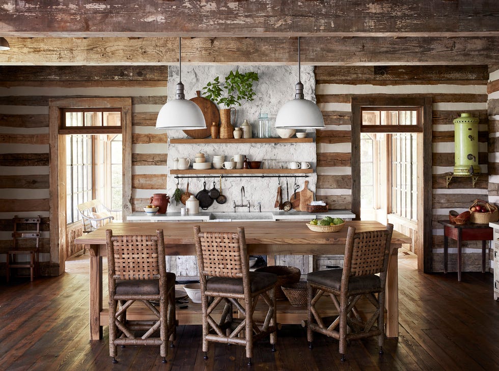 rustic mountain kitchen with white rustic factory lights, wooden topped island, and three bar stools