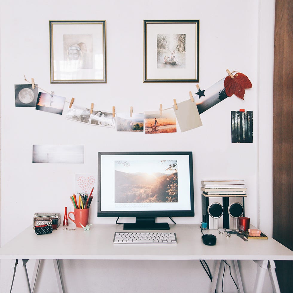 a photo wall in front of desk