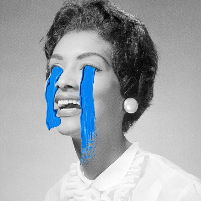 a black and white image of a woman crying painted on blue tears