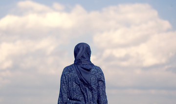 a woman wearing a hijab facing away from camera