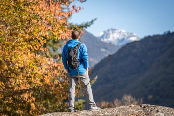 hiker explores mountainside in autumn