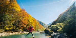 hiker relaxes near autumnal river