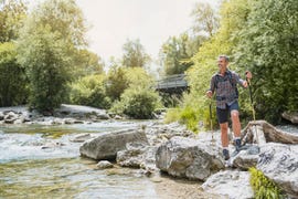 hiker standing at the riverbank