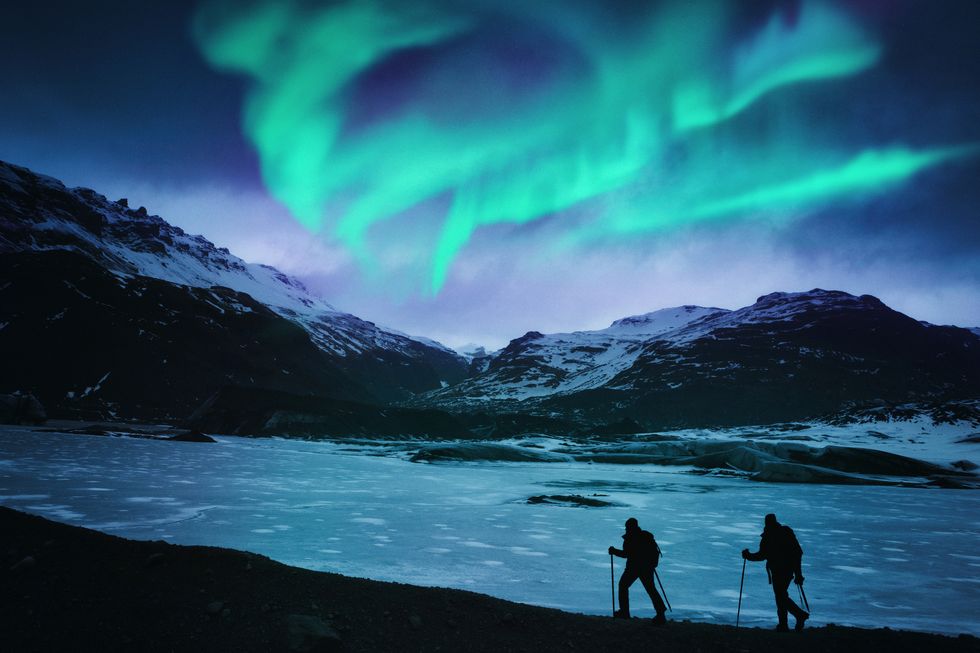 Hikers Under the Northern Lights