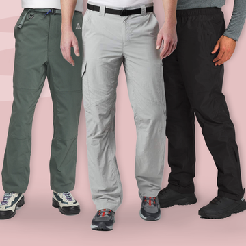 a group of people standing in front of a pink background a group of people standing in front of a pink background