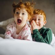 two children with red hair laughing