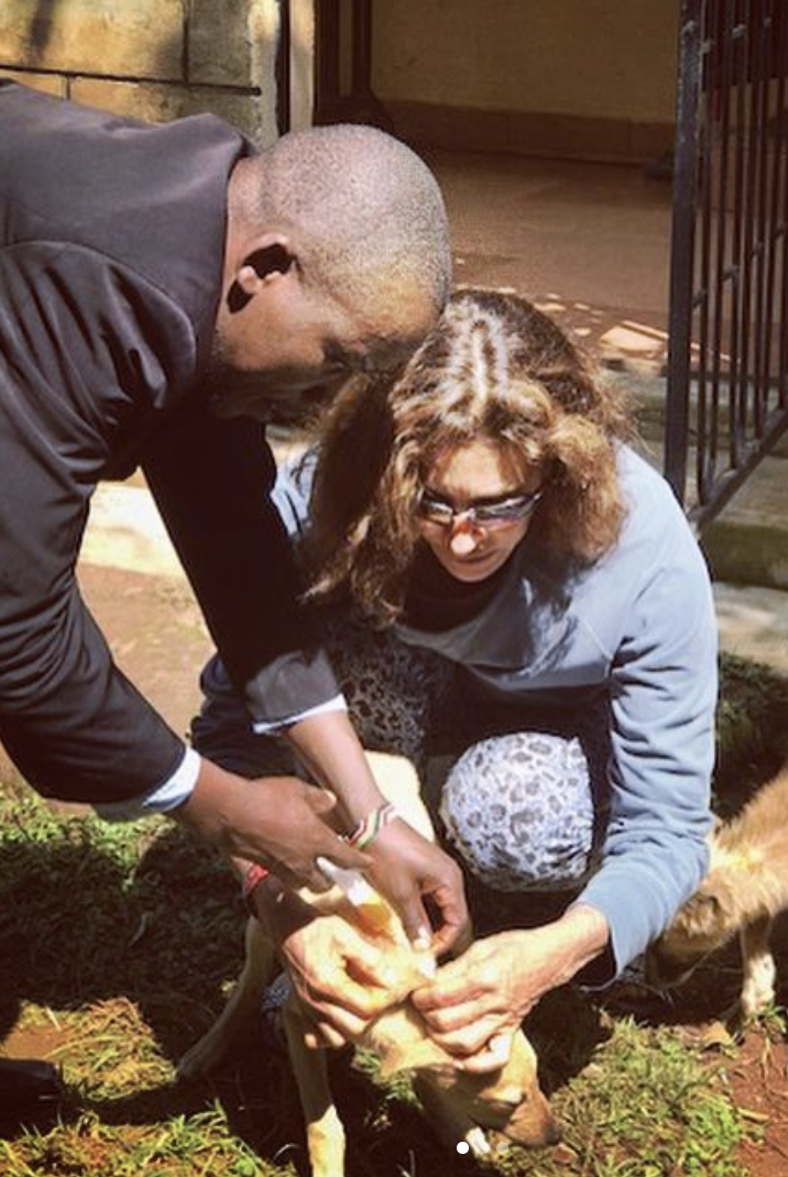 a man and woman petting a dog