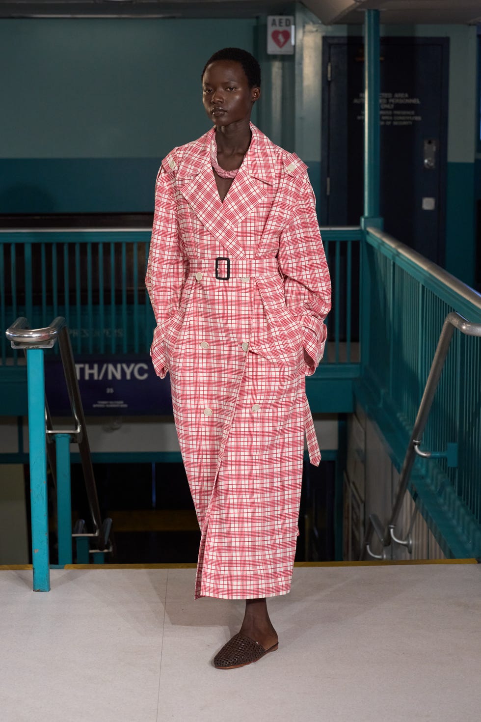 fashion model showcasing a plaid trench coat