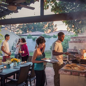 hipsters grilling at a summer backyard bbq