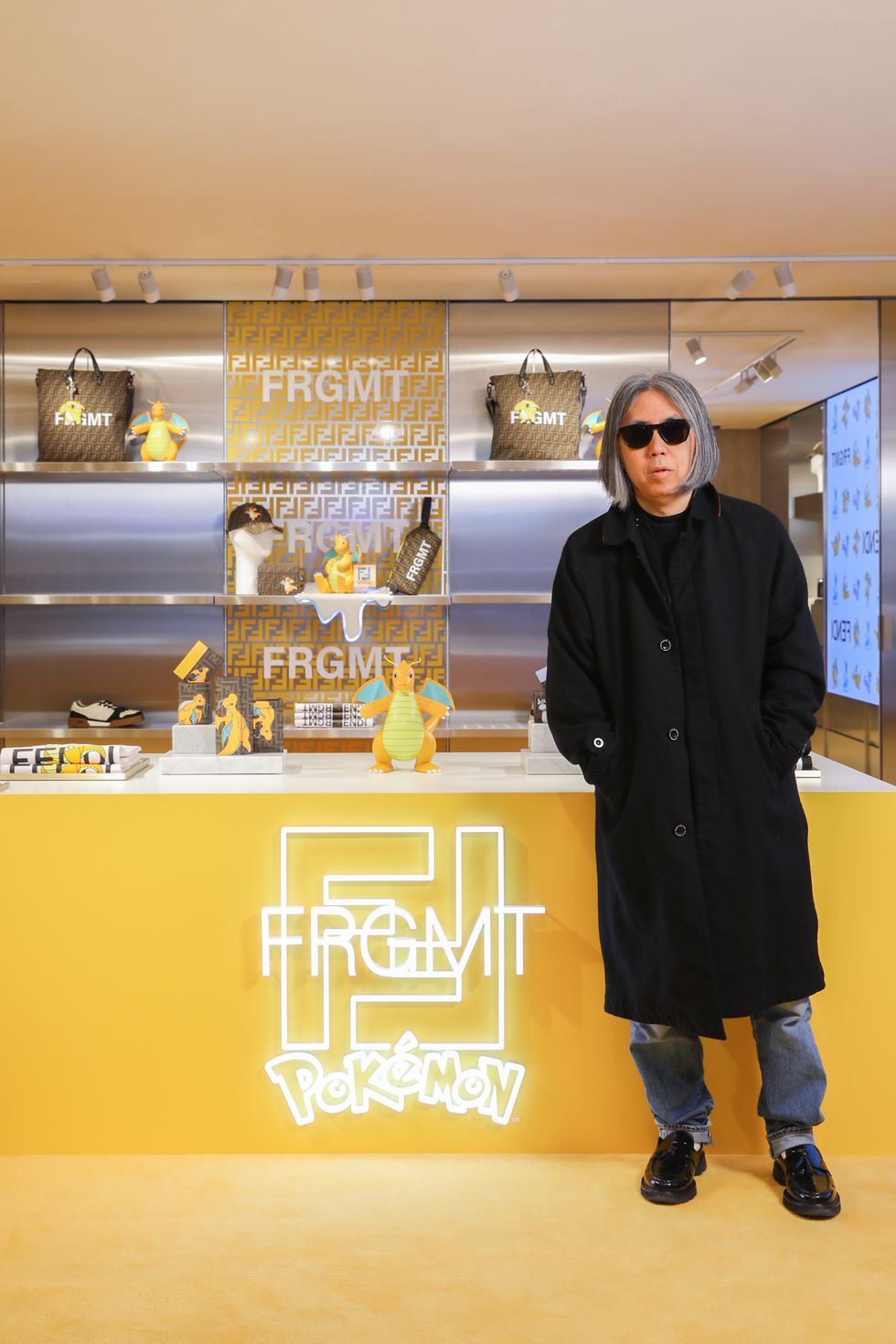 a man standing in front of a display of figurines