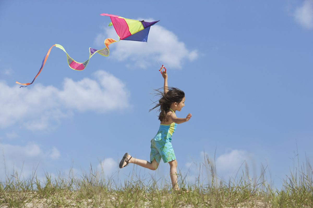 how to fly a kite, girl with kite in field
