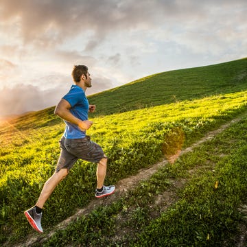 Hispanic man running on hill Hispanic man running on hill