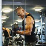 hispanic man weightlifting in gymnasium