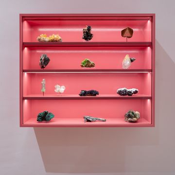 a red shelf with objects on it