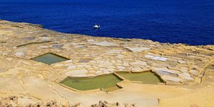 historic ancient salt pans on coast near marsalforn, island of gozo, malta