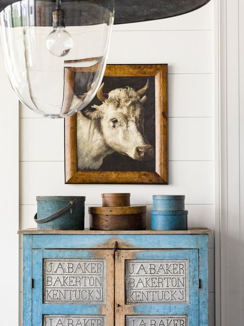 blue antique punched tin pie safe and cow painting