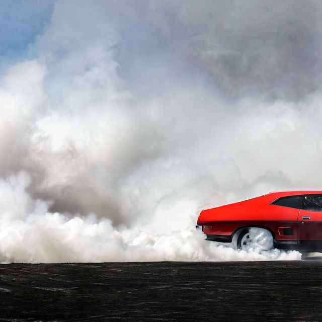 red car moving out of frame burning rubber