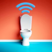toilet with wifi signal above it