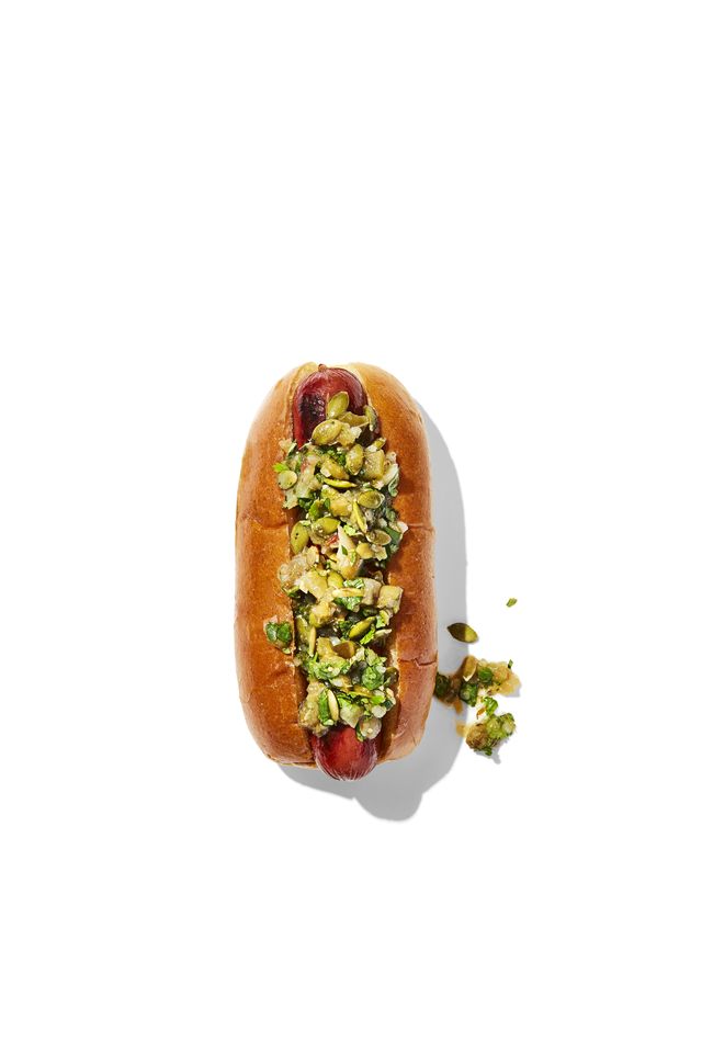 hotdog with toppings green salsa salsa verde, pumpkin seeds, cilantro, cumin