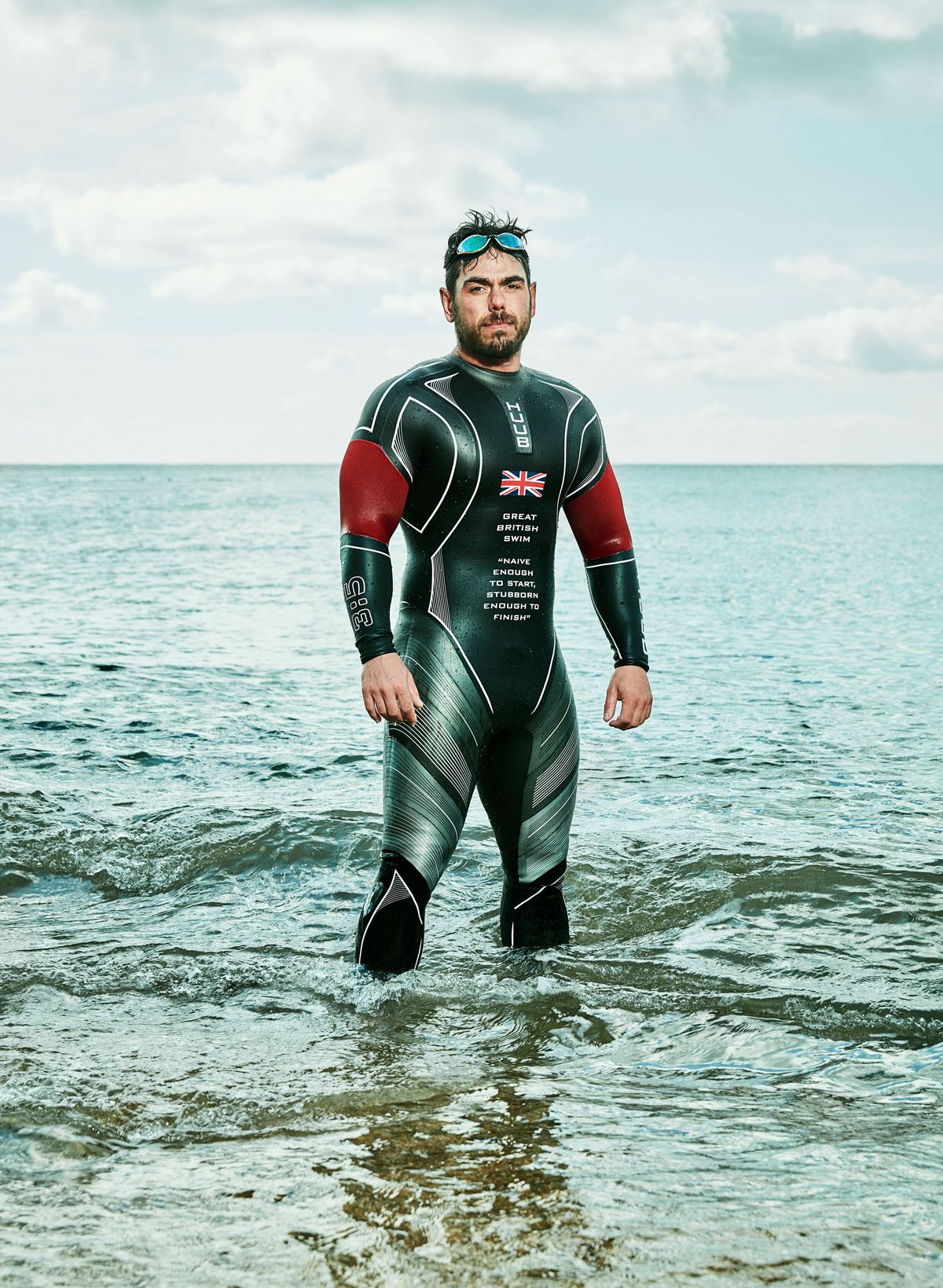 ross edgley in his wetsuit knee deep in the ocean