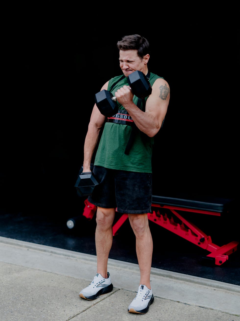 jeremy renner wears tank by jung maven shorts by abercrombie  fitch