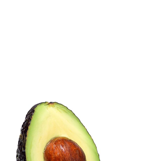 avocado half with pit and lime