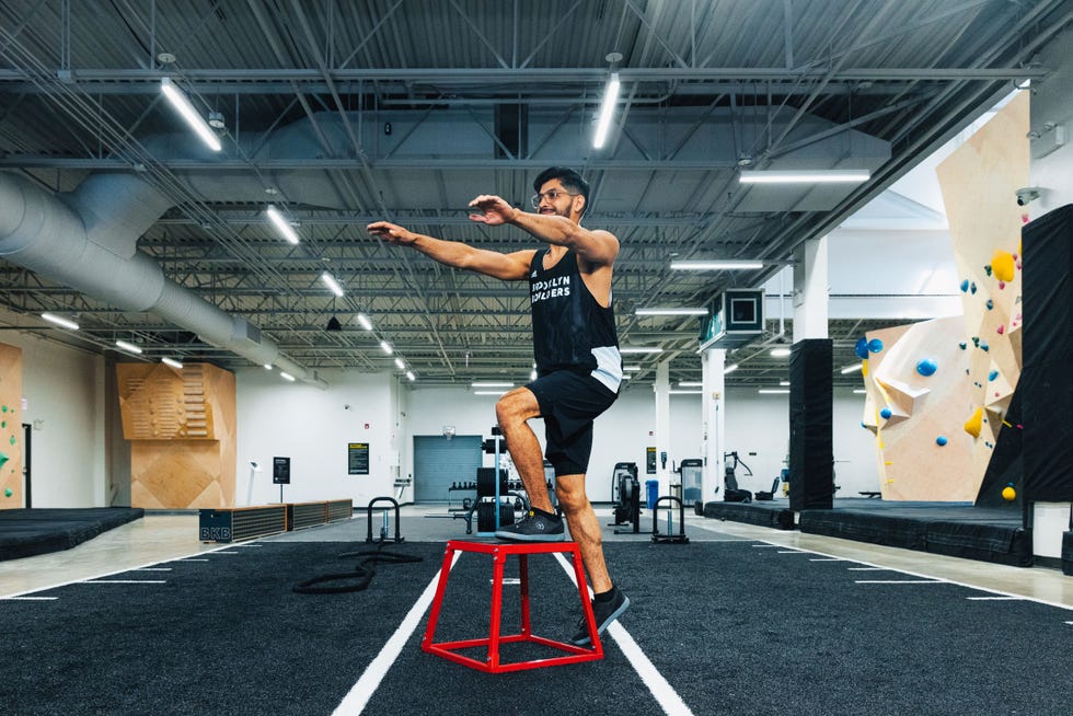 man stepping up on box in gym