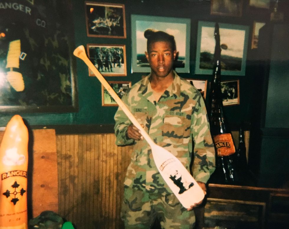young soldier holding oar